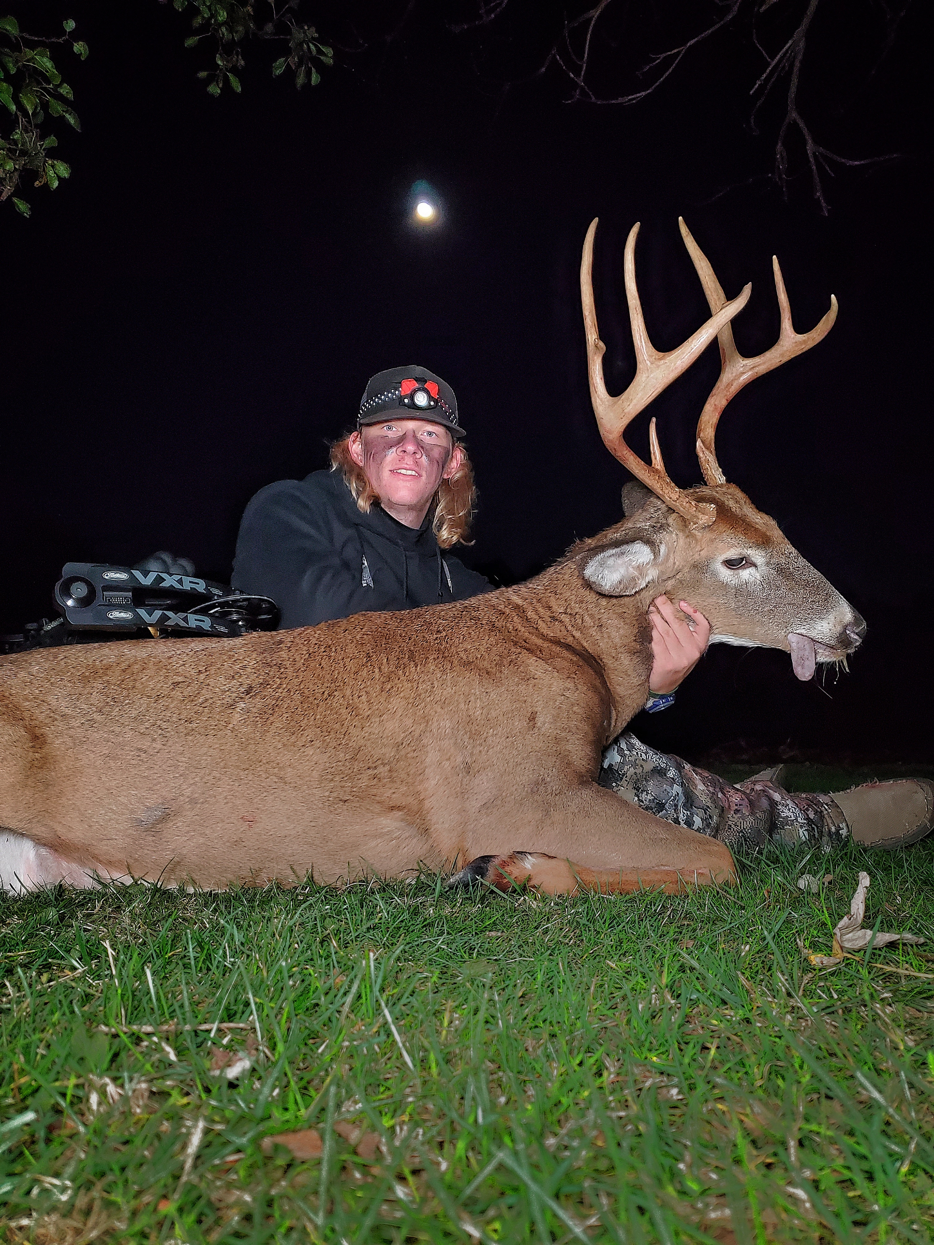 60x custom string staff shooter Colton Price sitting with a deer