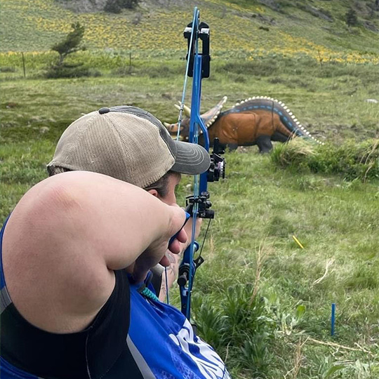 Shooter Rebekah Ham aims at a 3D target with some terrain