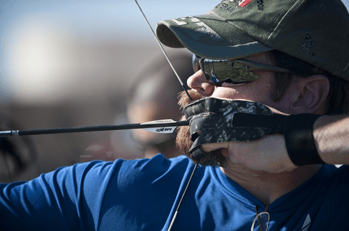 man aiming a target in archery 