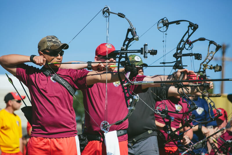 archers in competition aiming target