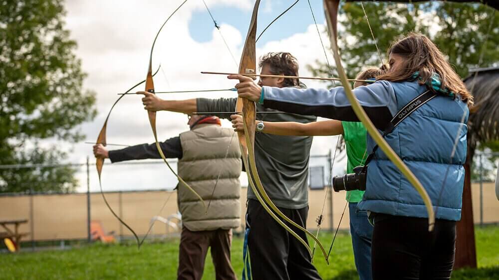 family practicing archery longbows