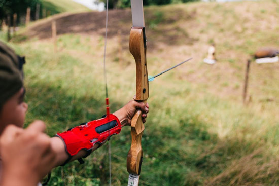 Field archer releasing his arrow