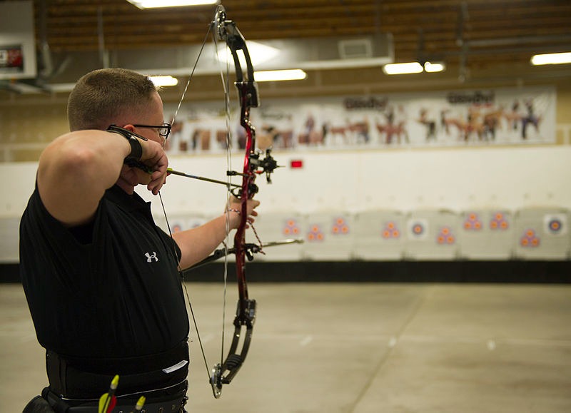 An archer at a shooting range takes aim