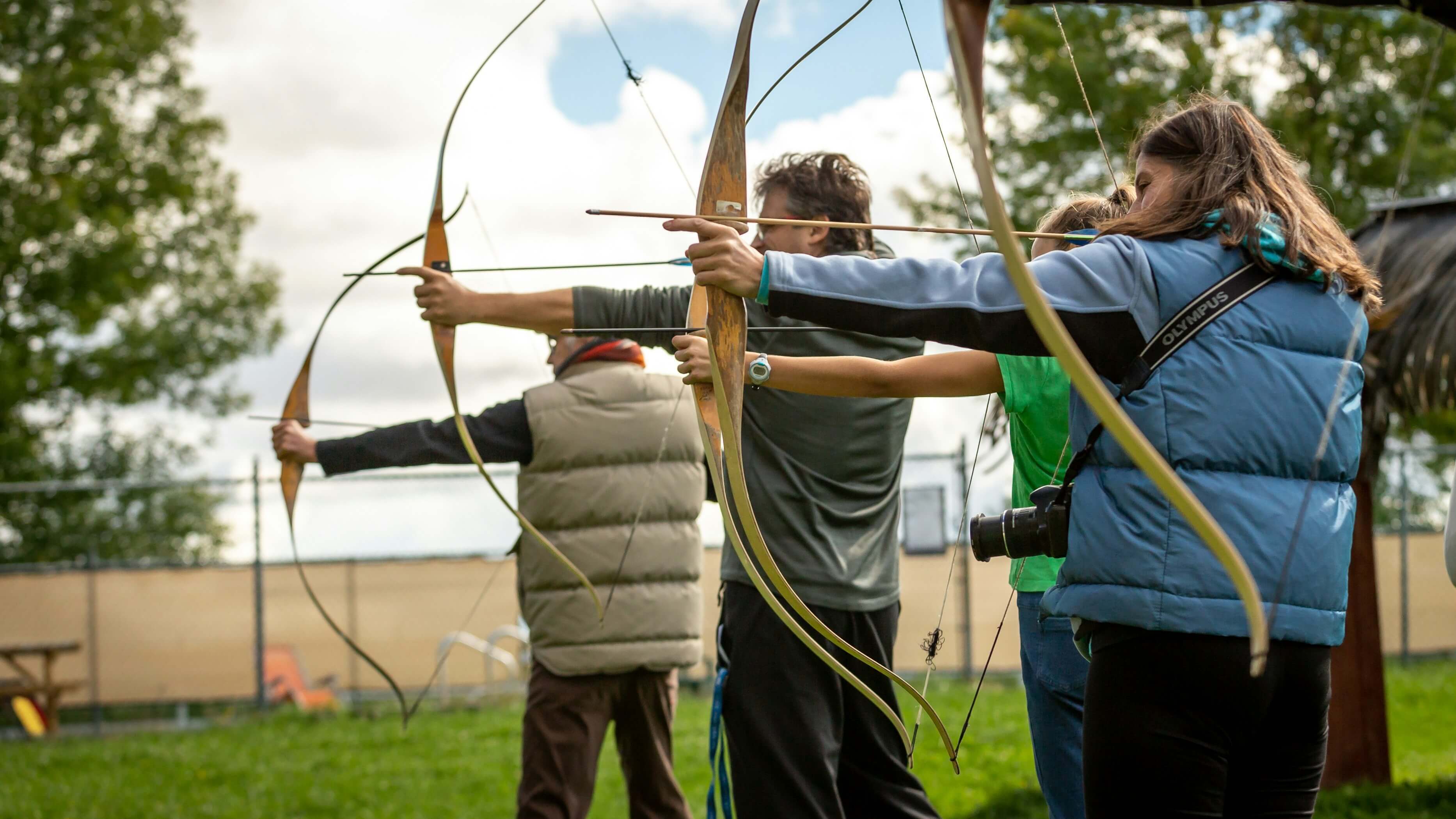 Three archers aiming at targets