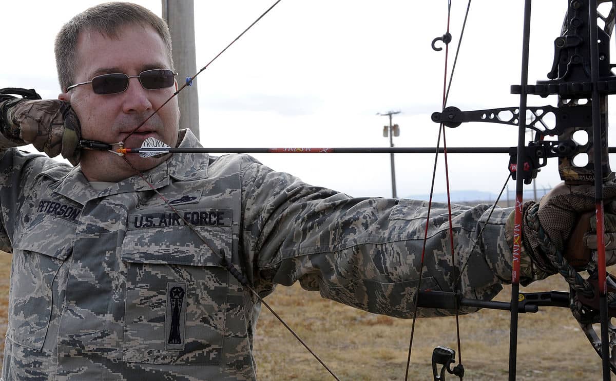  airforce man holding bow hunting equipment