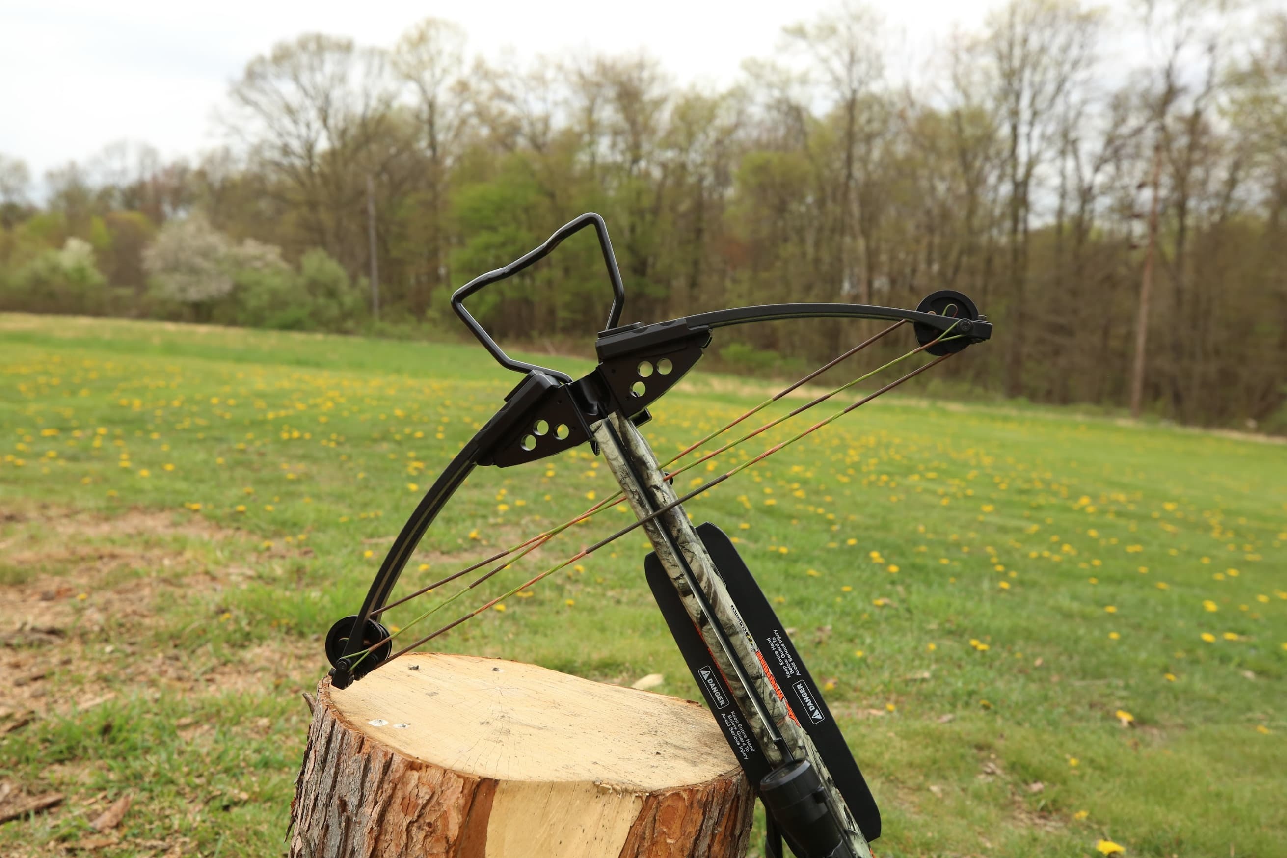 freshly restrung crossbow on a tree stump