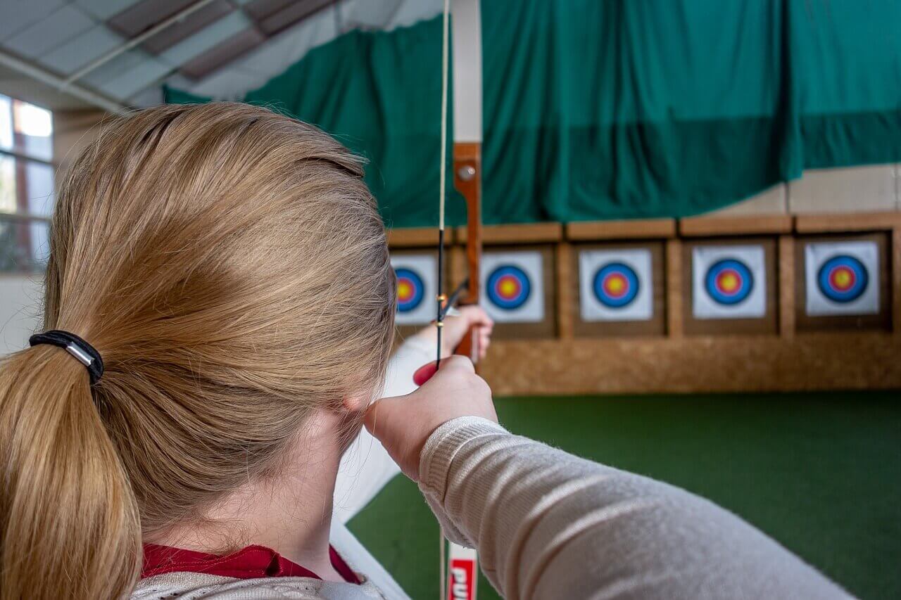 girls back view while aiming the target