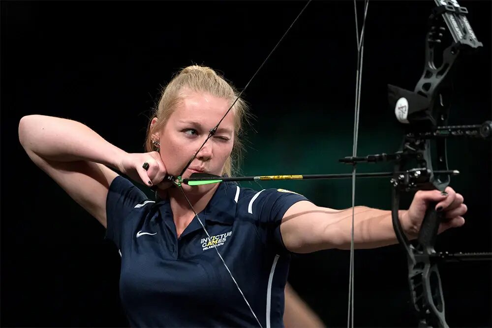 woman focus on aiming the target on archery